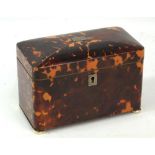 A 19th century tortoiseshell two division tea caddy of rounded rectangular form with pewter