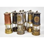 Six miners' safety lamps comprising three Protector Lamp & Lighting Co Ltd examples including