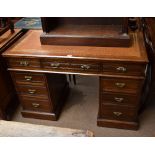 A late Victorian walnut nine drawer twin pedestal desk raised on a simple plinth, width 123cm.