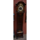 A 1930s oak grandmother clock with arched dial inscribed 'Tempus Fugit' and with Roman numerals to