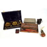 A small group of collectors' items including a cigarette box, pipe, match book box, hand grenade,