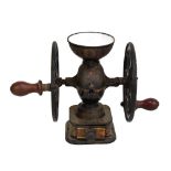 An unusual 19th century cast iron painted and enamelled coffee grinder with two handles, each set