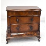 A Victorian mahogany chest with serpentine top drawer above two further long drawers.