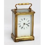 A French brass cased carriage clock, the circular dial set with Roman numerals, height excluding