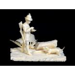 An early 20th century carved ivory huntsman and dog figure group on naturally modelled base, base