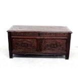 A late 18th century oak panel chest, fully restored and with Macclesfield carving to the top,