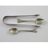 A pair of George III hallmarked silver sugar tongs and two non-matching hallmarked silver teaspoons,