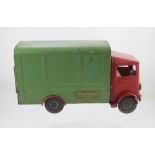 A vintage Tri-ang transport van with red cab and green body, bearing original transfer sticker,