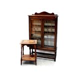 An Edwardian oak floor-standing bookcase with twin leaded doors on barleytwist frame base,