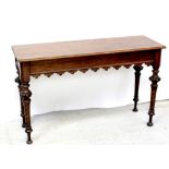 An Aesthetics oak hall table with shaped frieze apron and on turned tapering wrythen legs,