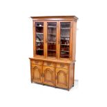 A late Victorian oak triple-front elevated bookcase,