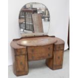 A c1950s walnut veneered twin pedestal dressing table with bowed two-drawer front, height 148.5cm.