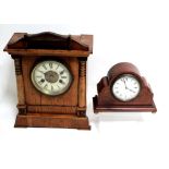 A Victorian walnut architectural mantel clock with twin-train movement striking on coiled rod,