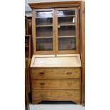 A light oak elevated bureau bookcase cabinet,