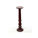 A mahogany jardinière stand on fluted column to lappet carved base, height 84cm.