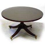 A 20th century mahogany reproduction tilt-top table on quadripartite pedestal base to brass slipper