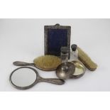 A hallmarked silver dressing table set comprising hand mirror, ladies' brush, gents brush,