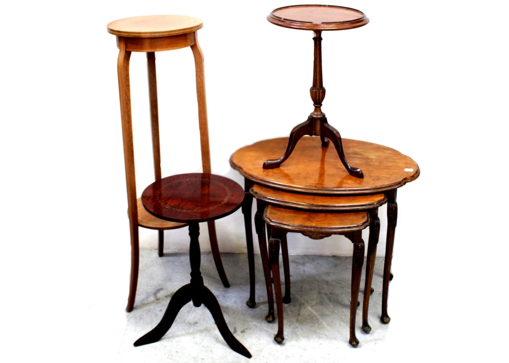 An early/mid-20th century nest of quarter-matched burr walnut tables on acanthus carved cabriole