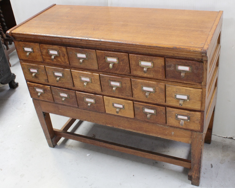 An early 20th century three-section oak library table/filing cabinet,