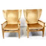 A pair of c1960s Parker Knoll armchairs finished in gold velour and on tapering beech legs,