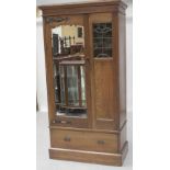 An early 20th century oak Arts & Crafts single mirror door wardrobe,