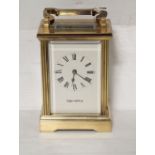 A mid to late 20th century Mappin & Webb brass carriage clock with lever escapement the white
