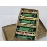 A collection of four Dinky Toys double decker buses, all in green and beige,