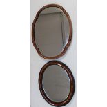 A Victorian walnut dressing table converted to a wall mirror and a simulated wood bevelled oval