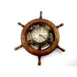 A brass ship's clock, 'Ship's Time', the gilded dial set with Roman numerals,