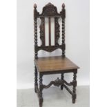 A Victorian Carolean style oak hall chair, carved top rail and plank seat with barleytwist supports.