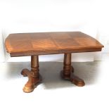 A mid/late 20th century French-style oak draw-leaf table on twin pedestal base, length 152cm.
