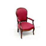 An early 20th century mahogany fauteuil upholstered in burgundy damask fabric and supported on