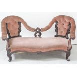 A Victorian mahogany Rococo conversation seat/sofa with shaped carved back finished in deep