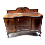 An early/mid-20th century mahogany serpentine-front sideboard,
