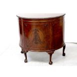 A good early/mid-20th century mahogany demi-lune cabinet with gadrooned edge over a single central