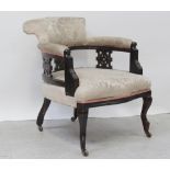 An Edwardian mahogany tub chair with flared back and on cabriole legs to porcelain castors,