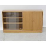 A mid/late 20th century floor-standing oak bookcase with adjustable shelves and glass sliding doors