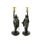 A pair of c1920 Egyptian Revival style cold painted bronze figural candlesticks,