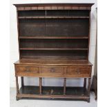 A 19th century oak dresser with cup hooks over two plate racks,