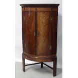 A George III flame mahogany bow-front floor-standing corner cupboard,