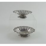 A pair of Victorian hallmarked silver filigree bonbon dishes on spreading oval bases,