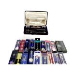 A cased hallmarked silver manicure set with small trinket pots, nail buffer and manicure items,