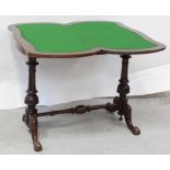 A Victorian walnut serpentine folding card table on twin-pillar base,