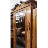 A Victorian Aesthetic walnut wardrobe with single mirror door and floral inlay to either side above