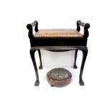 A 19th century mahogany piano stool, lift-up hide-covered seat for storage of music,