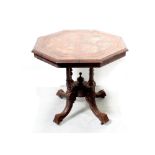 A Victorian walnut Aesthetics octagonal table on quadripartite support to castors, diameter 72cm.