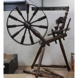 A 19th century oak spinning wheel with foot pedal operation, height 87cm.