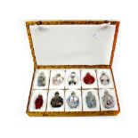 A cased set of ten snuff bottles, to include resin, glass, ceramic and hand-painted examples (10).