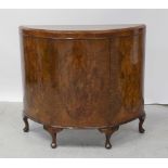 An early/mid-20th century walnut demi-lune cabinet,