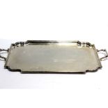 A George VI hallmarked silver twin-handled tray with stepped decoration to sides,